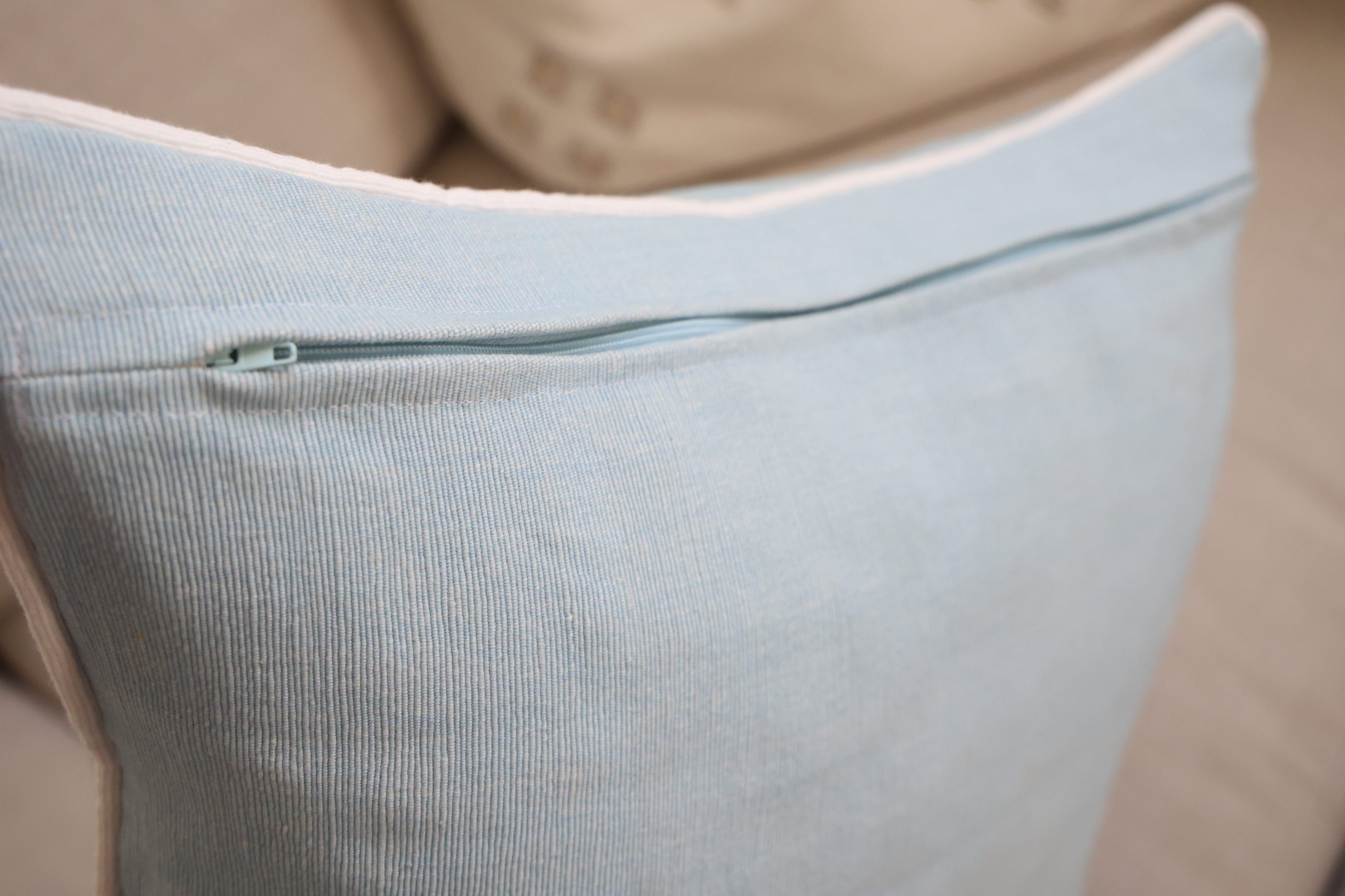 Blue cushion with white piping