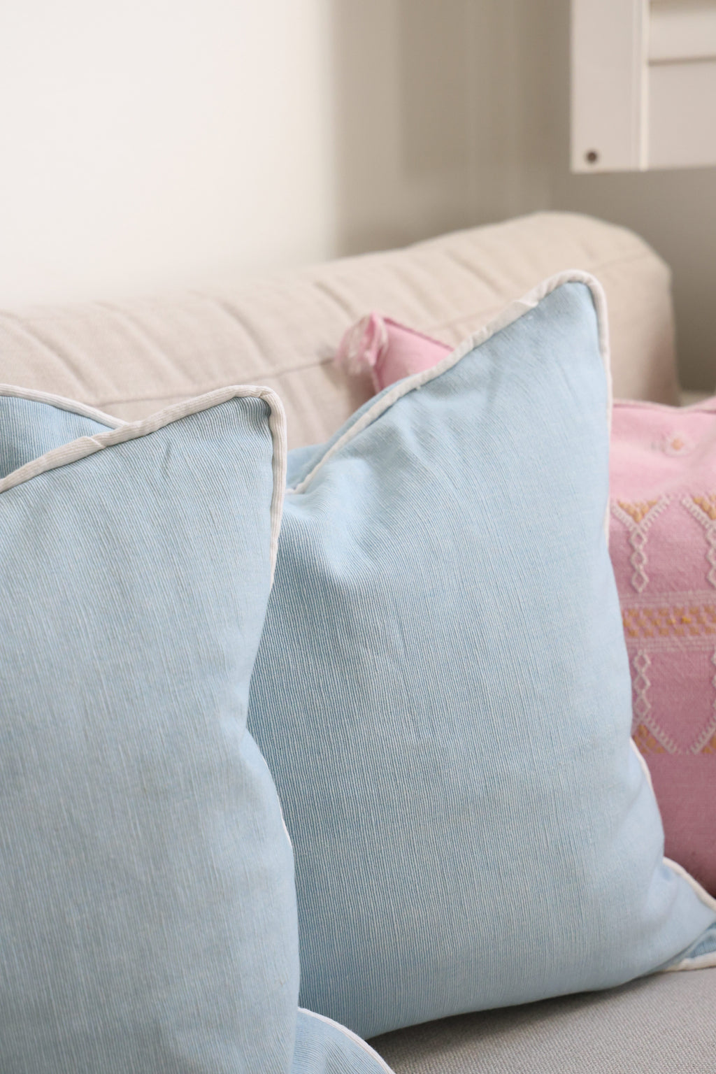 Blue cushion with white piping