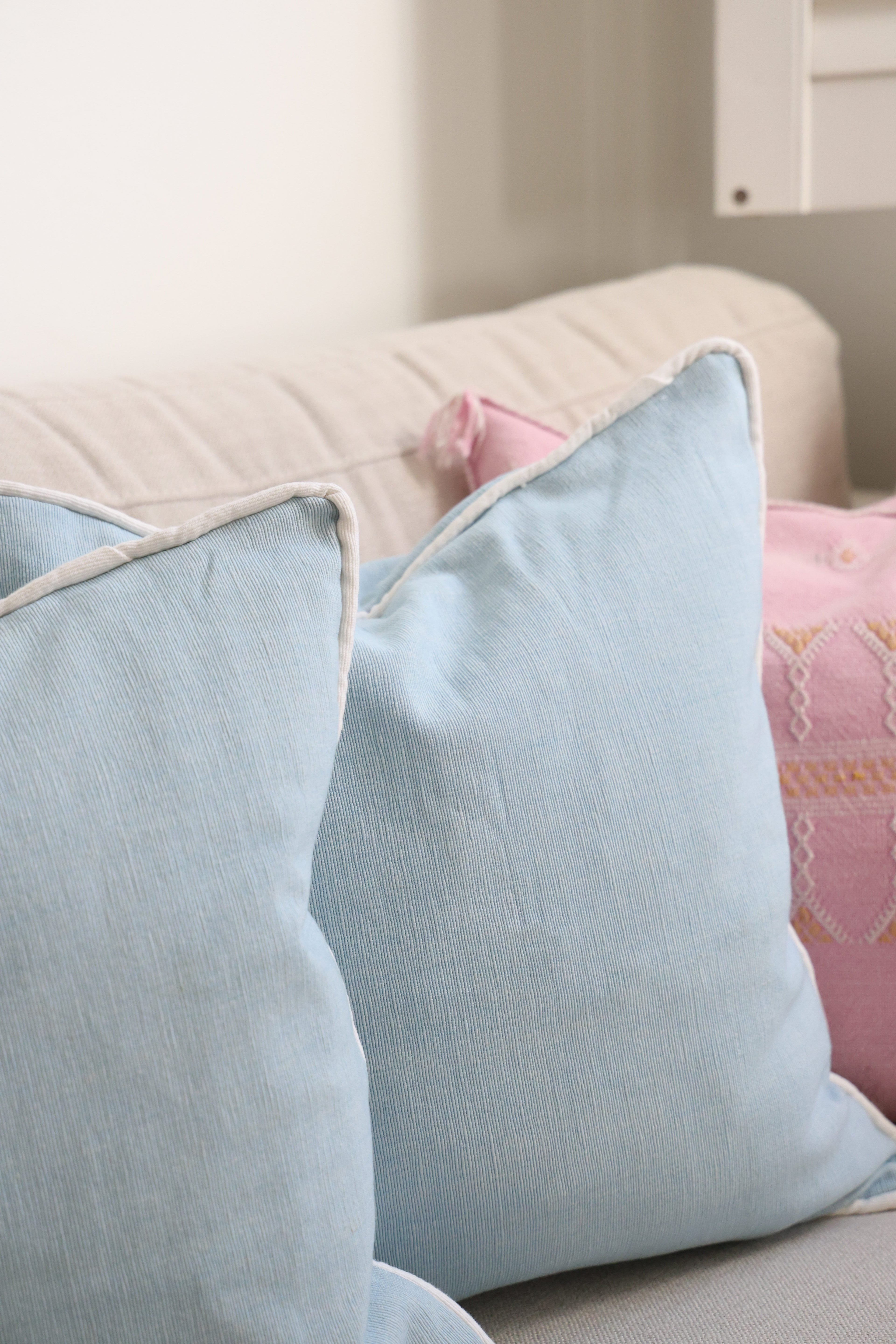 Blue cushion with white piping