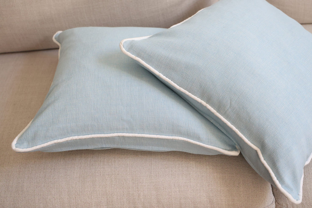 Blue cushion with white piping