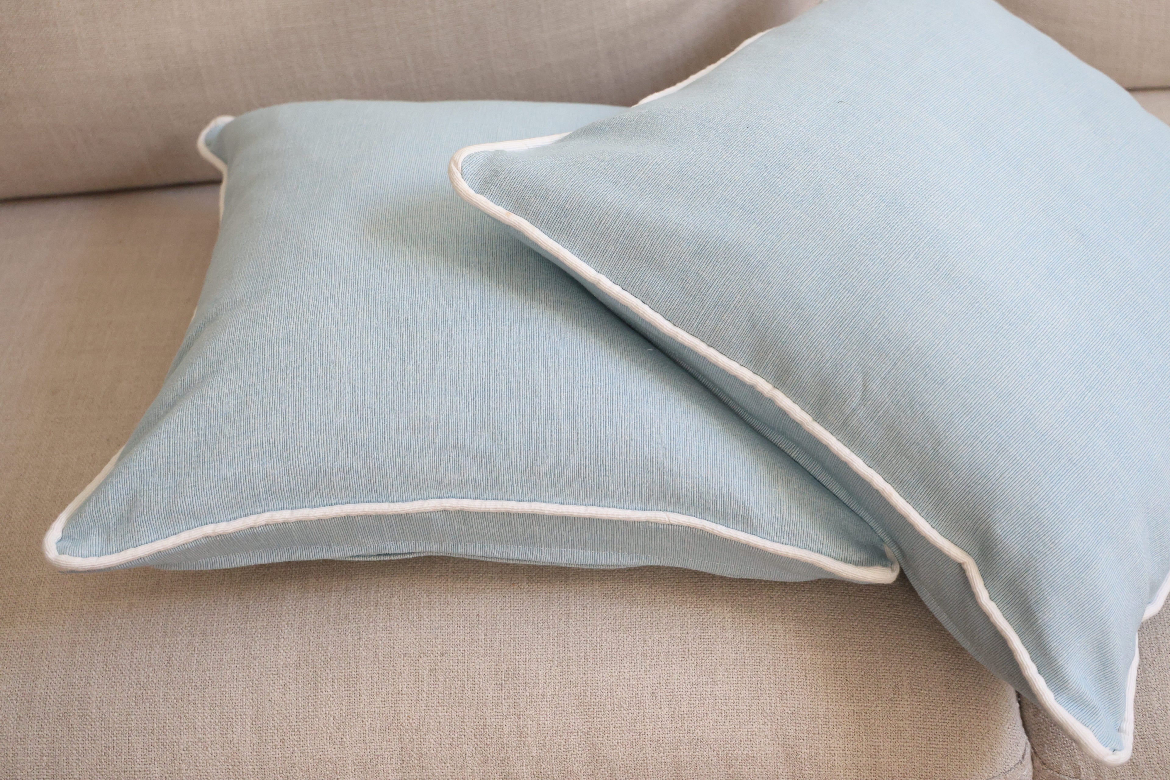 Blue cushion with white piping