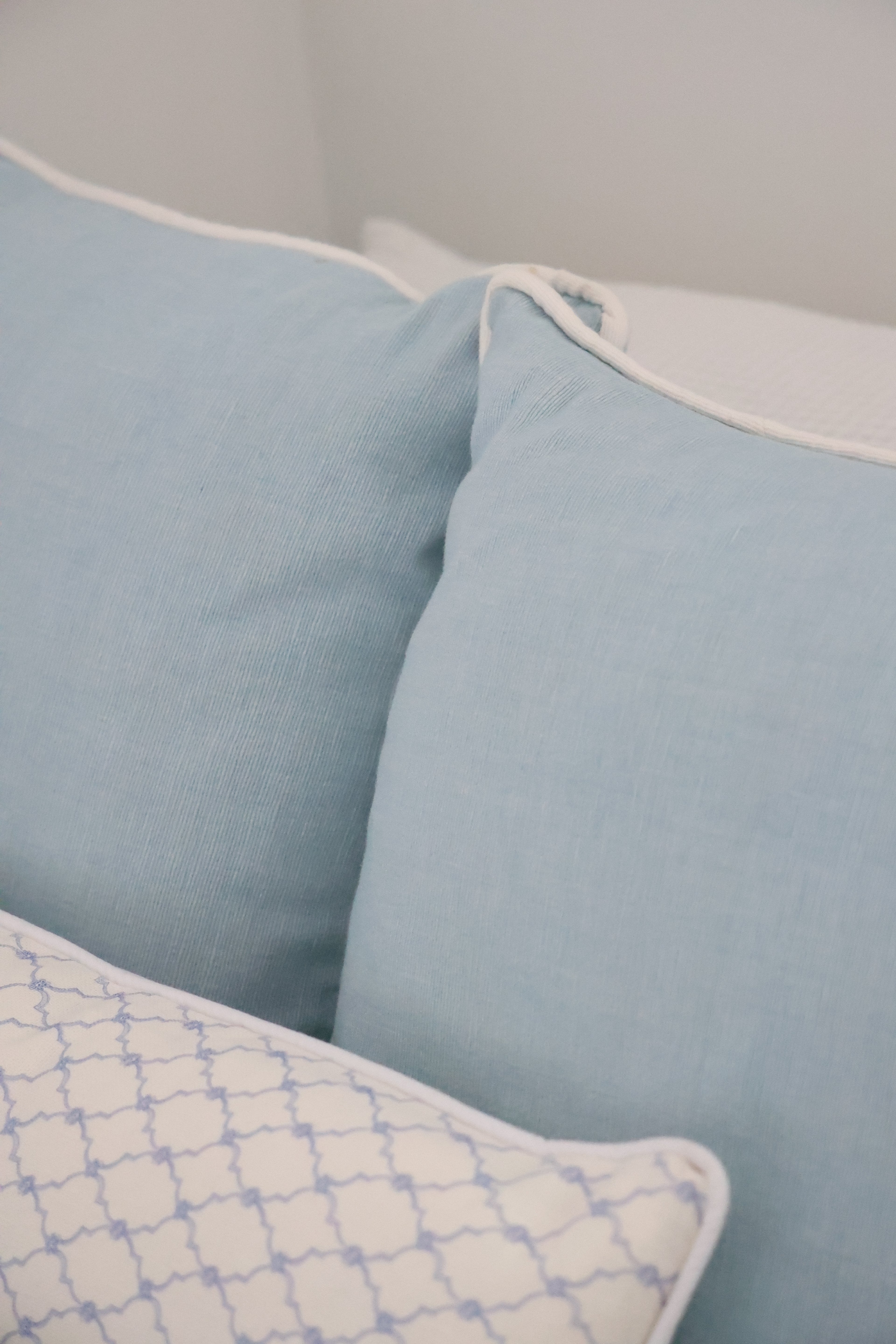 Blue cushion with white piping